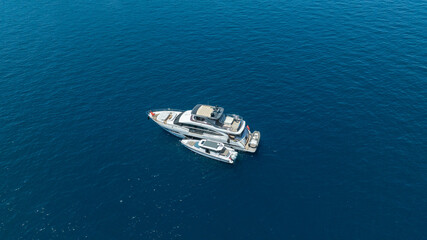 Fototapeta premium A breathtaking aerial view of a luxurious yacht cruising on the blue waters