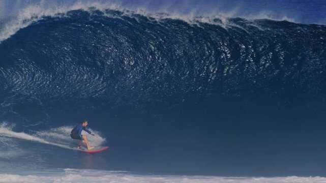 Tracking follows surfer gliding effortless at base of heavy wave pulling into deep barrel, Cloudbreak Fiji