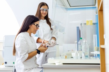 Two scientists working together in a modern laboratory.