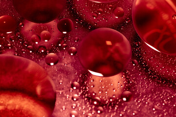 Close-Up of Red Oil Bubbles in Water. A striking close-up of red oil bubbles suspended in water....