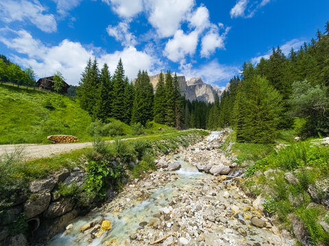 Photo of a stream in Val di Fassa with Sass Pordoi in the background - Italy