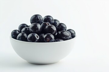 Fresh blackberries in a white bowl on a light background for healthy eating