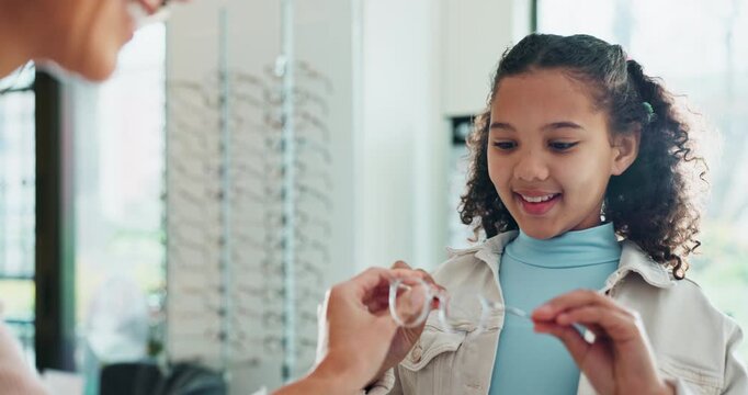 Helping, woman and glasses for child, smile and vision for girl, fitting and happy with option of healthcare. Shopping, customer and eyewear in shop, optician and employee with choice for kid