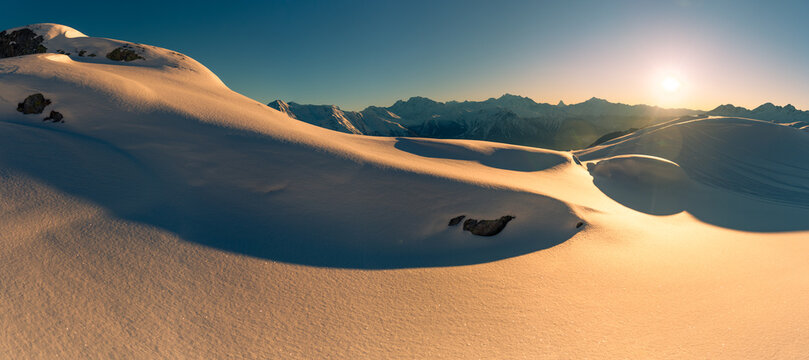 Snowy Swiss landscape illuminated by sunrise