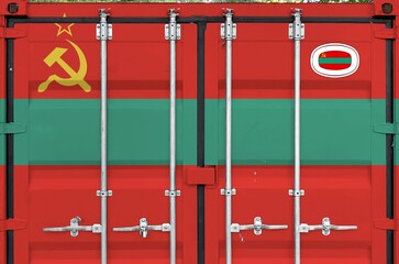 Transnistria flag depicted on metal doors of shipping cargo container outdoors in docks area close up