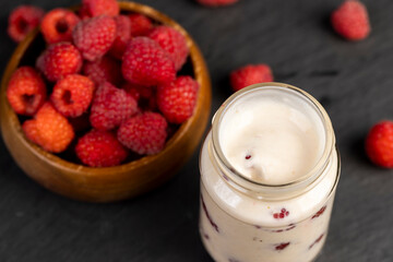 delicious and fresh yogurt with raspberry flavor and whole red raspberries