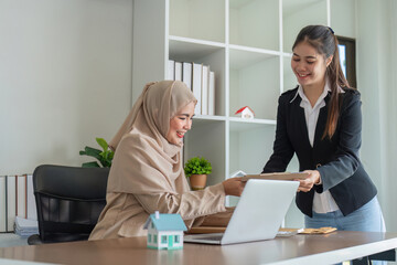 Muslim Real Estate Agent Discussion Property Deal with Client in Modern Office Setting