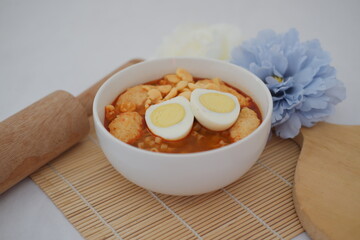 spicy egg noodle soup with crackers