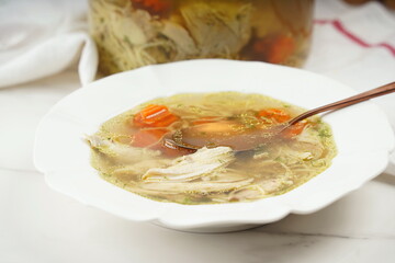 Chicken soup, chicken broth, with pieces of chicken and vegetables. Chicken bouillon, boiled meat