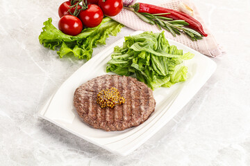 Frilled beef burger cutlet with iceberg