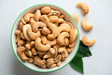 Roasted cashews in a bowl, top view. Marketplace food image