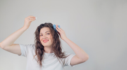 Fototapeta premium Beauty blogger demonstrating hair growth solution application, enhancing elasticity and reducing breakage and split ends.
