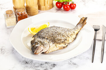 Baked Dorado fish served lemon