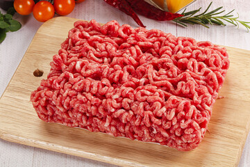 Raw minced beef meat over board