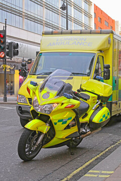 NHS Ambulance Van and Motorcycle at Parked Street in City Centre London United Kingdom