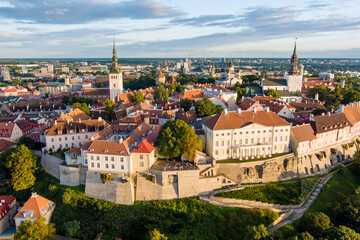 Iconic aerial skyline view of Tallinn Old Town and Toompea hill on a sunny summer evening. Stenbock House, Patkuli viewing platform, defensive walls, rooftops.