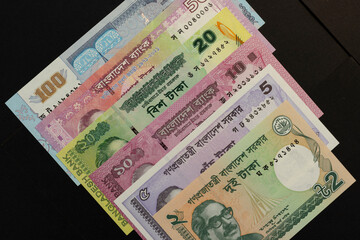 Bangladeshi taka currency notes isolated black background