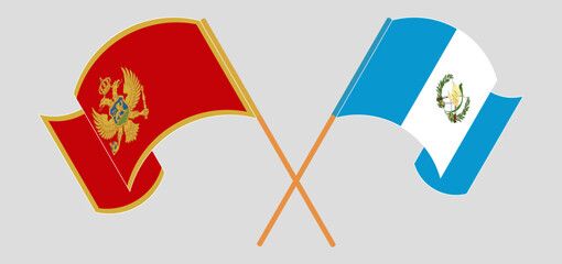 Crossed and waving flags of Montenegro and Republic of Guatemala