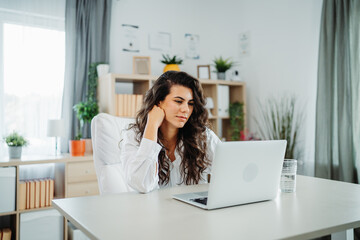 Young caucasian business woman working in office on laptop 