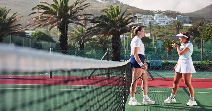 Conversation, fitness and tennis players on court with racket and ball for practice together with team. Discussion, sports and women athletes by net for strategy plan for match, competition or game.