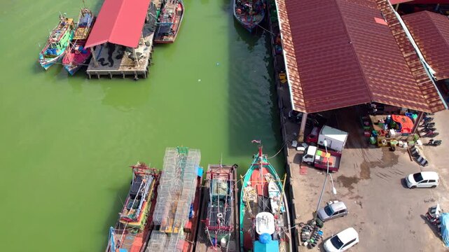 Aerial view of a colourful fisherman boat at the jetty in Besut. 4K