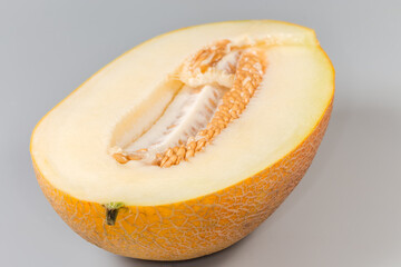Half of yellow melon with seeds, close-up, selective focus