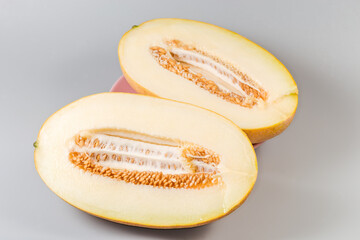 Halves of yellow melon with seeds, close-up, selective focus