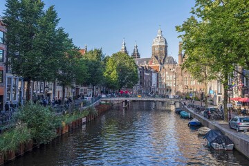 View over a typical canal in the Dutch metropolis Amsterdam in summer 2023