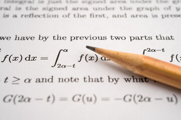 Pencil on mathematic formula exercise test paper in education school.