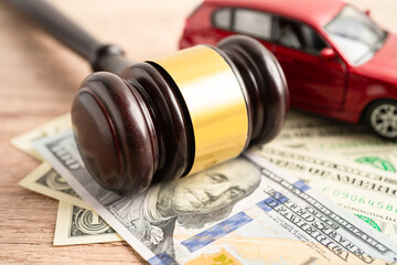 Hammer gavel judge and US dollar banknote money with car vehicle accident, insurance coverage claim lawsuit court case.