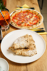 Italian dessert - calzone filled with chocolate, banana and powdered sugar at a restaurant