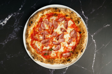 Original Italian pizza with ham, tomato sauce and cheese