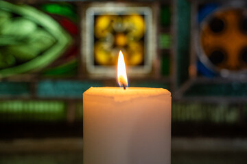 One candle flame at night in church closeup - isolated, macro.