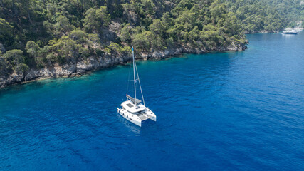 Stunning drone shot of a catamaran navigating the open sea.