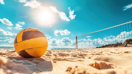 Volleyball on a sandy beach under a bright blue sky with a net in the background, ideal for sports and summer themes 