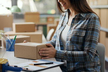 Woman holding a small delivery box