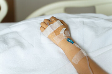 Intravenous saline. Sick People, Close up of hand are lying and being treated in beds in hospitals.