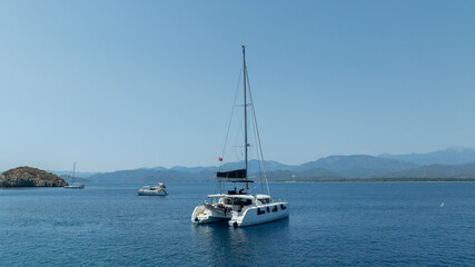 The beauty of a catamaran cruising, seen from above.