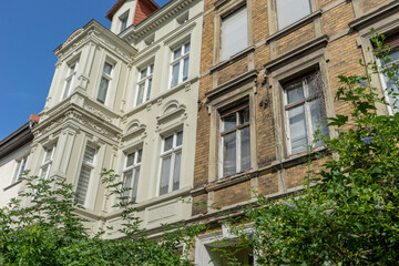 A renovated and a dilapidated terraced house with several floors