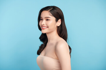 Obraz premium Beautiful Young transgender woman with clean fresh skin on blue background, Face care, Facial treatment, Cosmetology, beauty and spa, transgender women portrait.