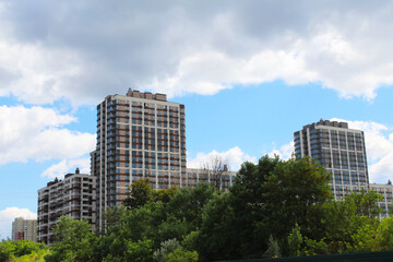 city skyscrapers, new apartment building on the background of a cloudy blue sky.
