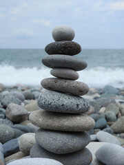 stone pyramid,  stacked pebble stone tower at beach