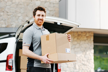 Professional delivery man loading packages into a minivan