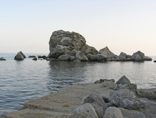 Rocks in the sea near the shore on a summer day