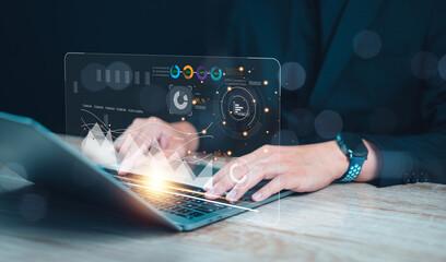 Businessman using modern laptop with virtual interface graphic, analyzing data and managing digital applications in office environment.