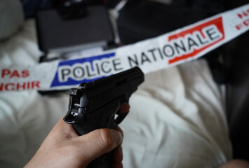 french national police crime scene tape , handgun and crime evidence