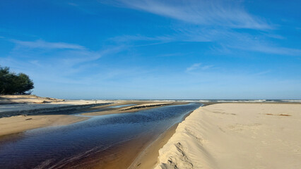 Crystal clear river passing through the dunes