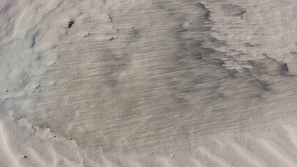 Close-up of the texture of the sand on the beach.