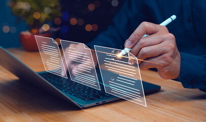 A person uses a stylus to interact with digital documents on a laptop, symbolizing modern digital...