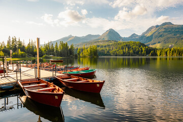 Red boats on Mountain lake Strbske pleso. Strbske lake with view of the High Tatras National Park, Slovakia